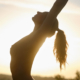 naked woman silhouette doing yoga at sunset