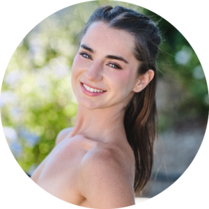 brown haired woman smiling looking at camera